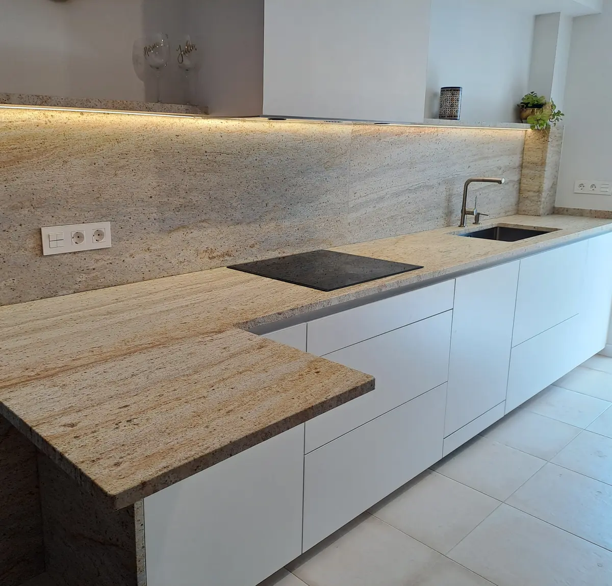 Marble countertop with stone integrated overhang lighting in Vigo